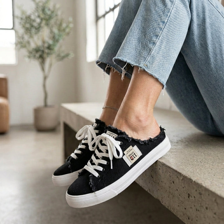 Emma & Rose Cape Town mule slippers featuring cowboy-inspired design with leather accents and cozy interior.