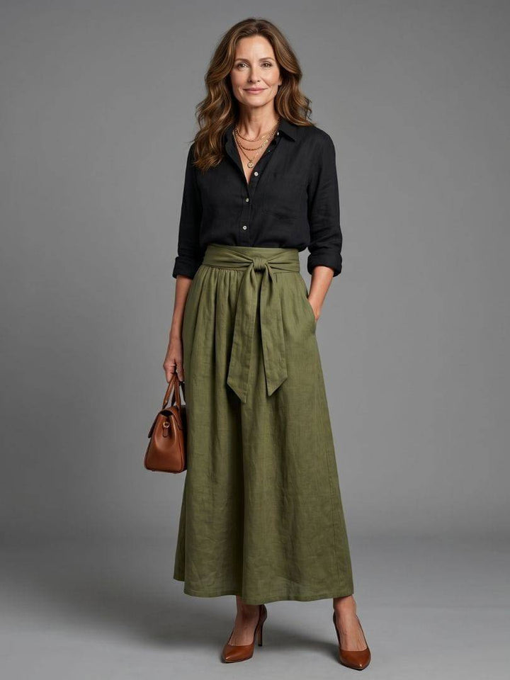 Olive green Vera™ midi skirt by Emma & Rose Cape Town, shown on a hanger with a plain background.