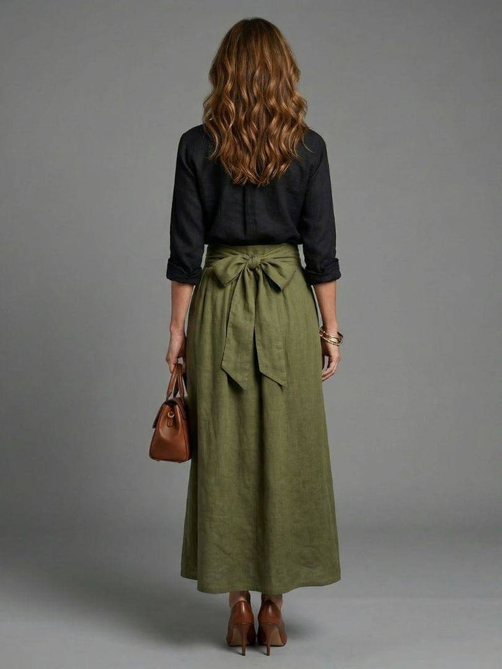 Olive green Vera™ midi skirt by Emma & Rose Cape Town, styled with a flowing fabric and high waist design.