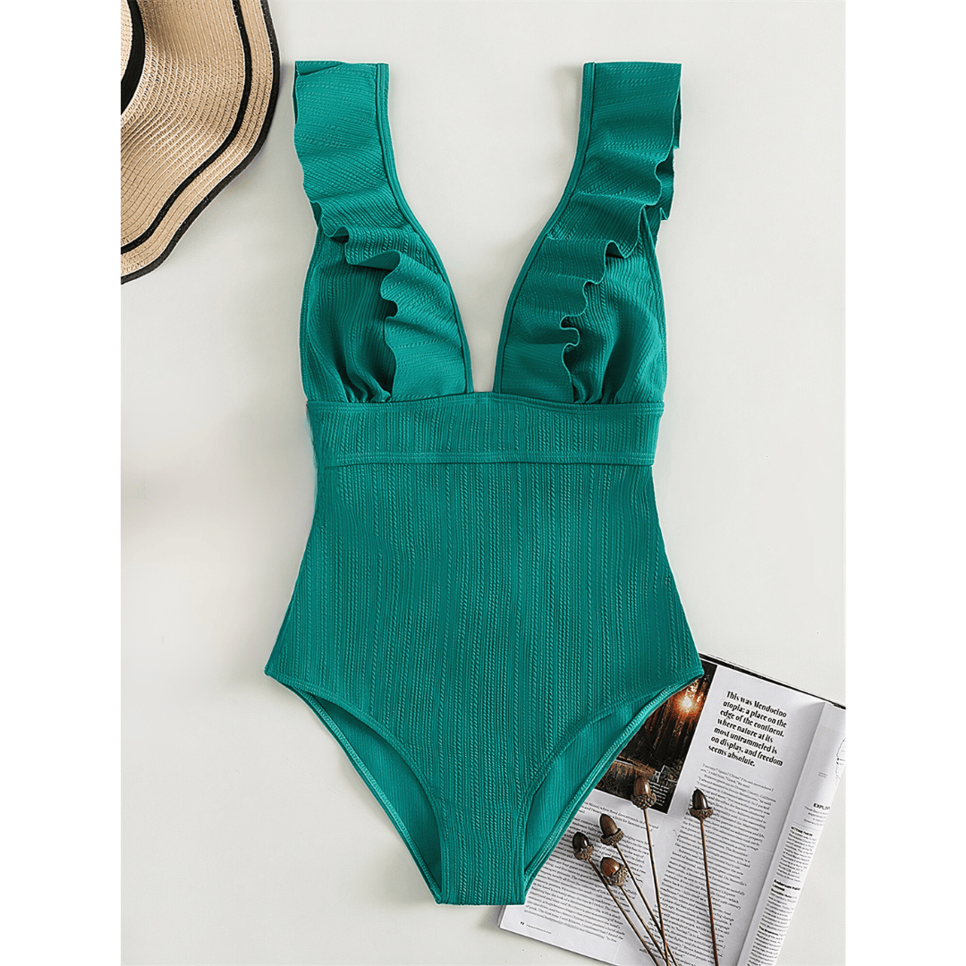 Olivia™ Mirage Swimsuit by Emma & Rose Manhattan displayed on a hanger with a vibrant, patterned fabric and sleek design.