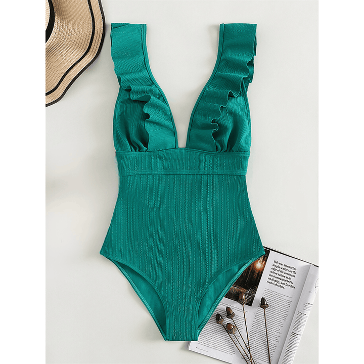 Olivia™ Mirage Swimsuit by Emma & Rose Manhattan displayed on a hanger with a vibrant, patterned fabric and sleek design.