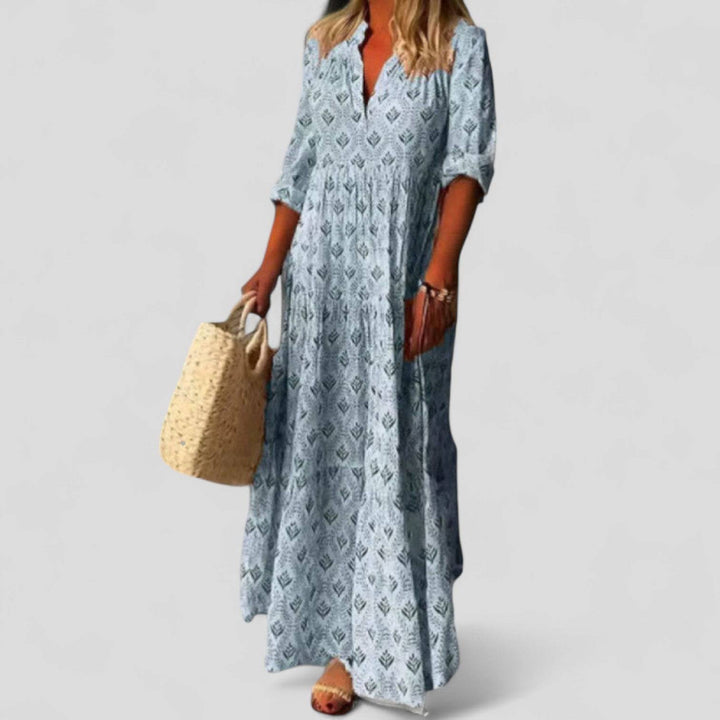 Elegant Marcivine™ maxi dress by Emma & Rose Cape Town, flowing fabric with a sophisticated silhouette and detailed neckline.