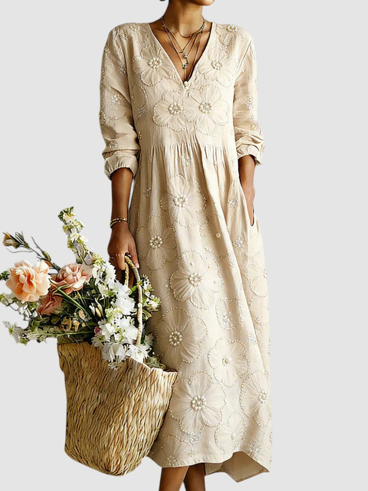 Floral midi dress by Emma & Rose Cape Town featuring a flowy fabric and vibrant flower print on a light background.