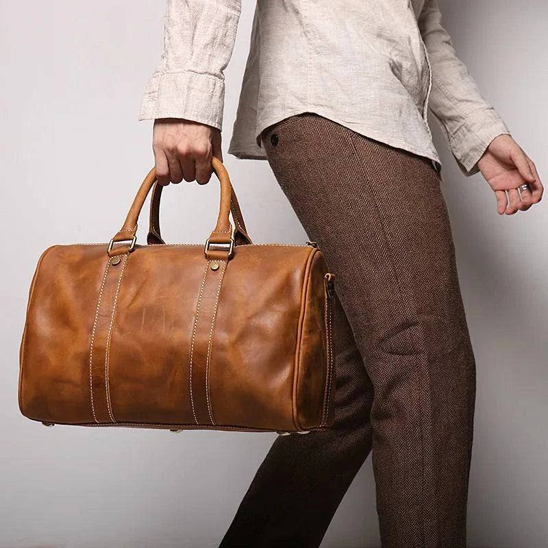 Emma & Rose Manhattan Riley Roma Duffle Bag in stylish fabric with leather accents, featuring sturdy handles and spacious interior.