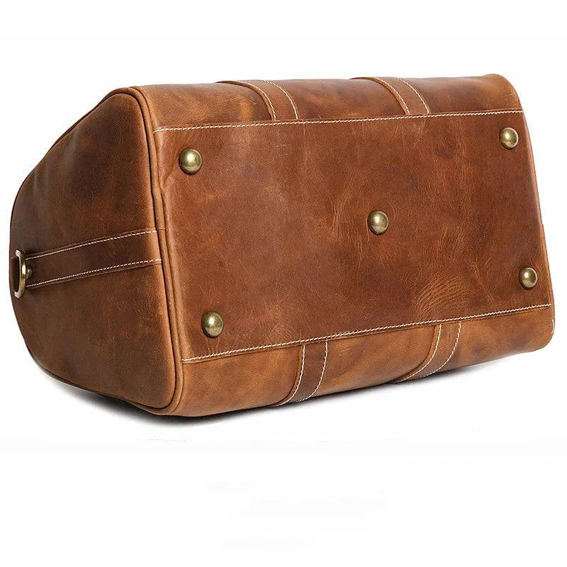 Emma & Rose Manhattan Riley™ Roma Duffle Bag in tan leather with handles and zipper closure, stylish travel accessory.