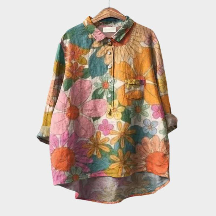 Elegant Sia™ blouse by Emma & Rose Cape Town featuring a stylish design, displayed on a hanger against a neutral background.