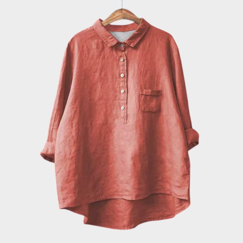 Elegant Emma & Rose Cape Town Naja™ blouse with intricate detailing, displayed on a hanger against a neutral background.