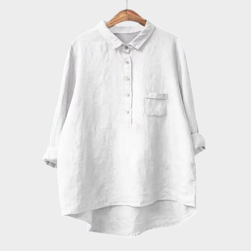 Elegant Emma & Rose Cape Town Naja™ blouse with intricate lace detailing and flowing fabric, displayed on a hanger.