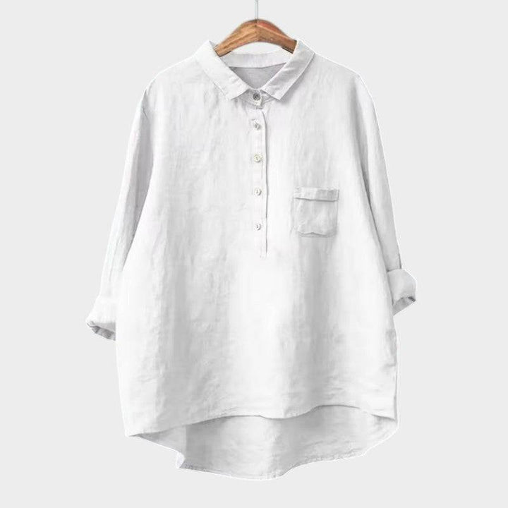 Elegant Emma & Rose Cape Town Naja™ blouse with intricate lace detailing and flowing fabric, displayed on a hanger.