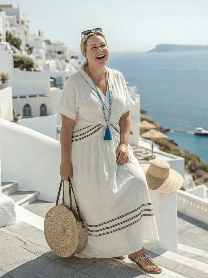 Seren™ wrap midi dress by Emma & Rose Cape Town featuring short sleeves, V-neck, and a stylish wrap design.
