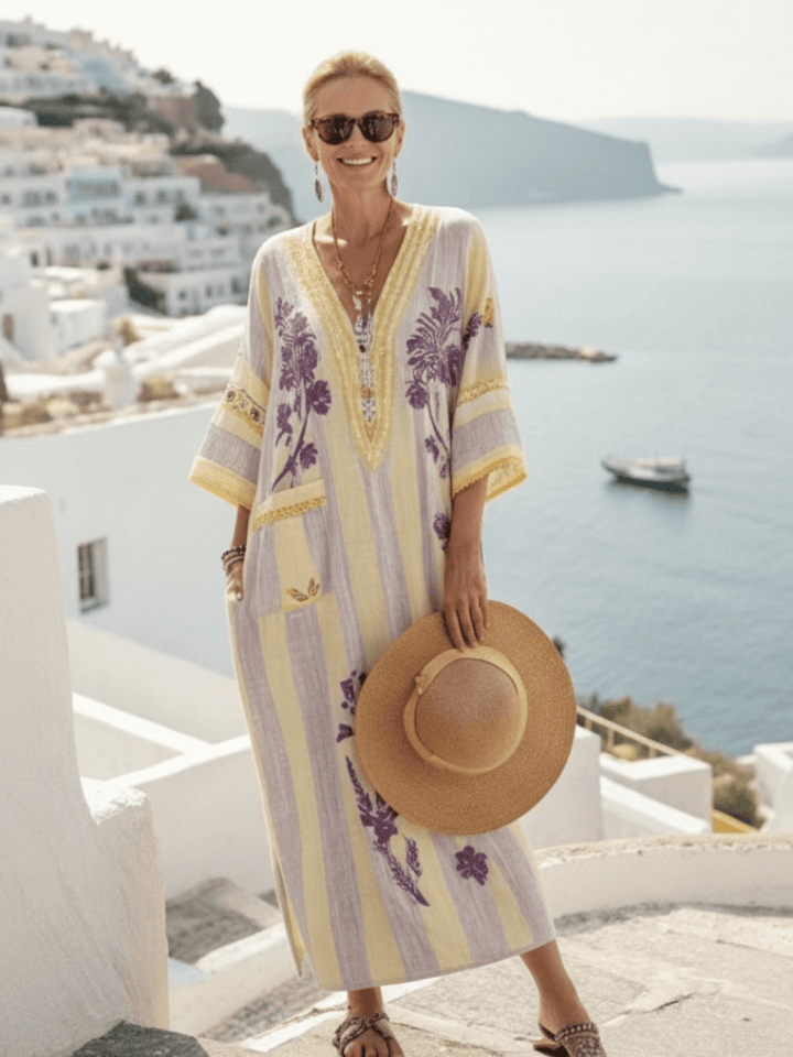 Aurelia™ striped floral maxi dress by Emma & Rose Cape Town, featuring flowing fabric and vibrant floral and stripe patterns.