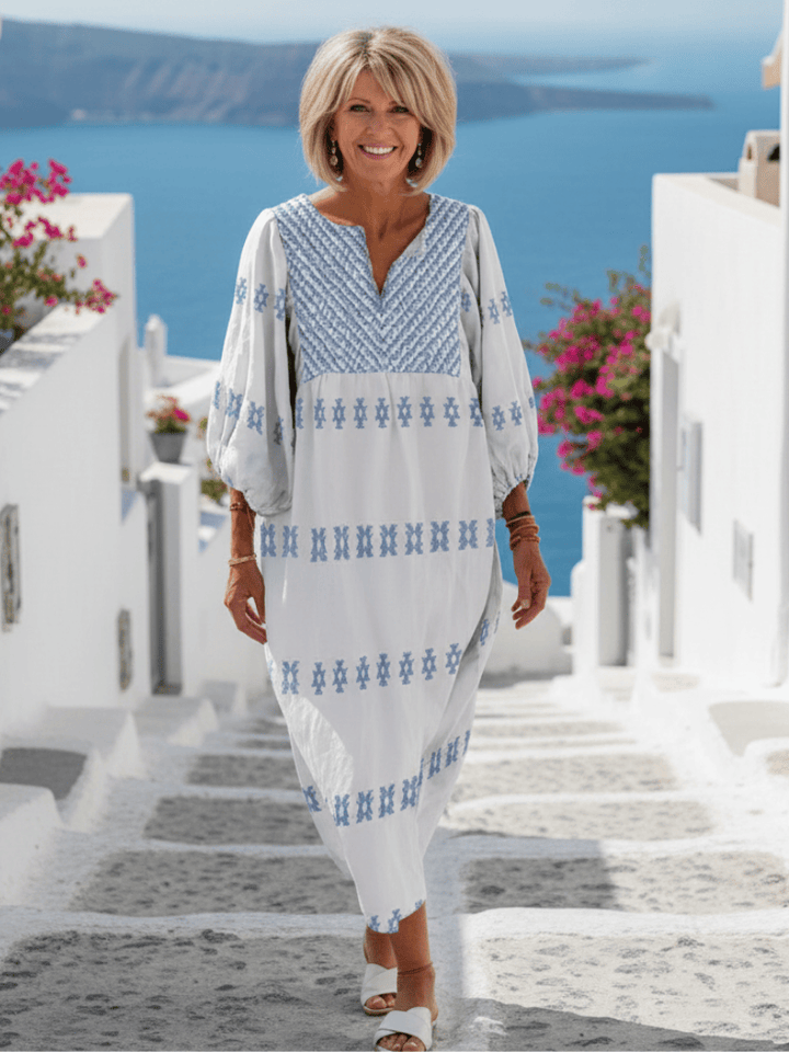 Evadne™ embroidered sleeve maxi dress by Emma & Rose Cape Town, flowing fabric with intricate embroidery and long sleeves.