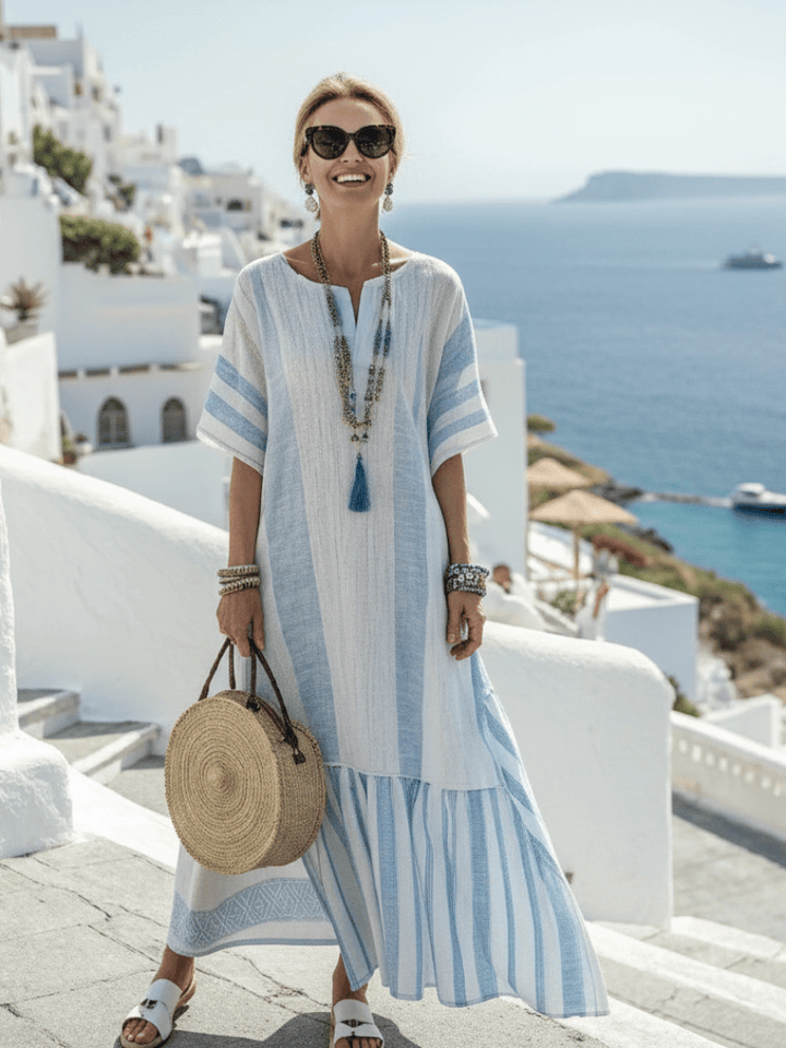 Emma & Rose Cape Town Ione™ striped maxi dress with long sleeves, flowing fabric, and a stylish, casual design in a vibrant pattern.