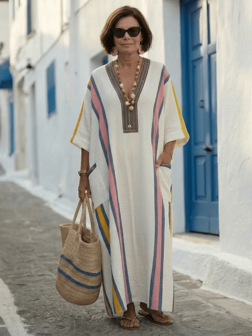 Noemi™ sleeve pocket maxi dress by Emma & Rose Cape Town, featuring flowing fabric and stylish pockets, shown on a model.