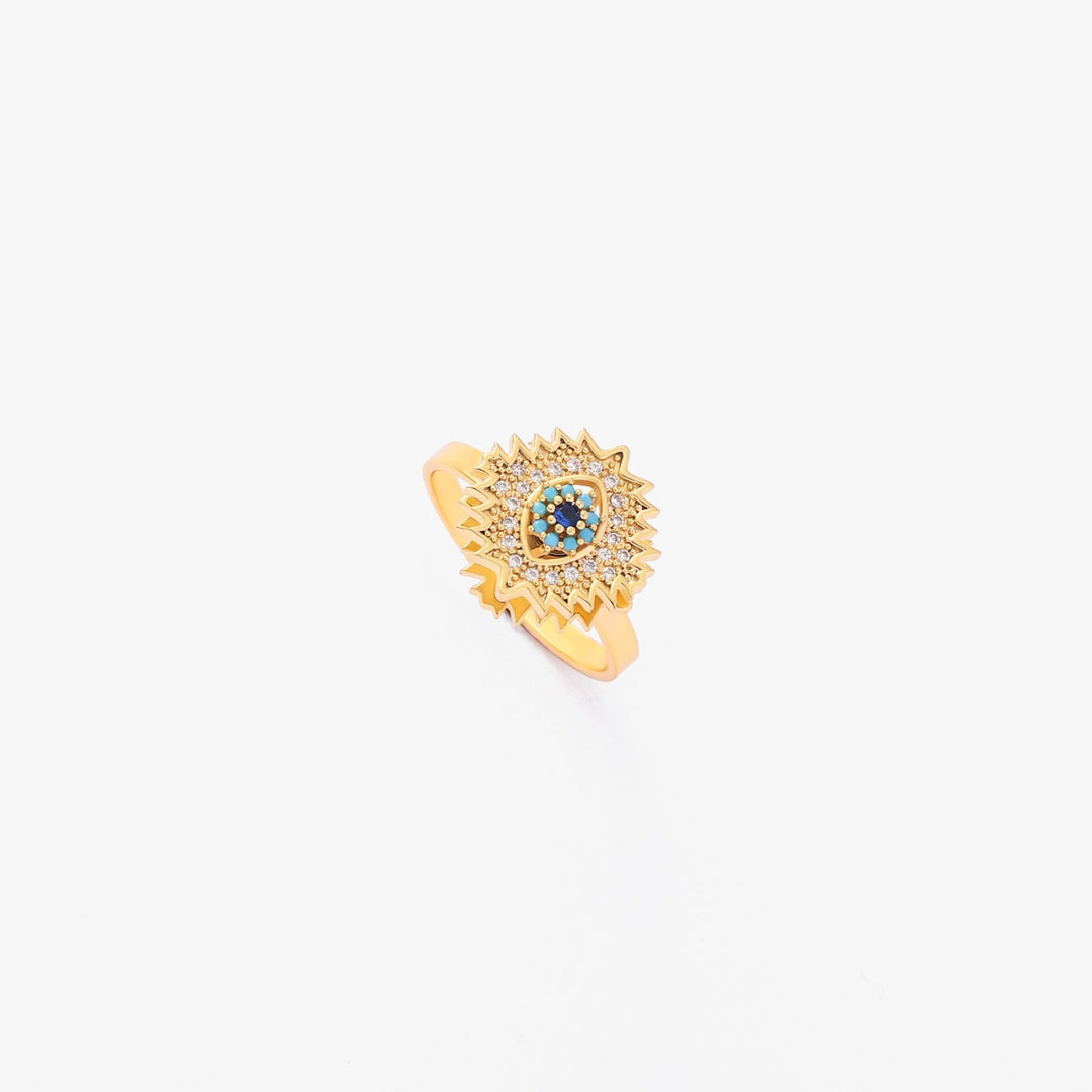 Gold twist ring with sapphire and sunburst design
