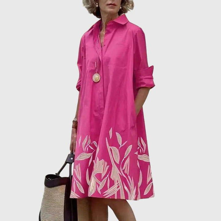 Emma & Rose Cape Town Paige™ elegant dress with stylish pockets, featuring a flowing fabric and a sophisticated design.