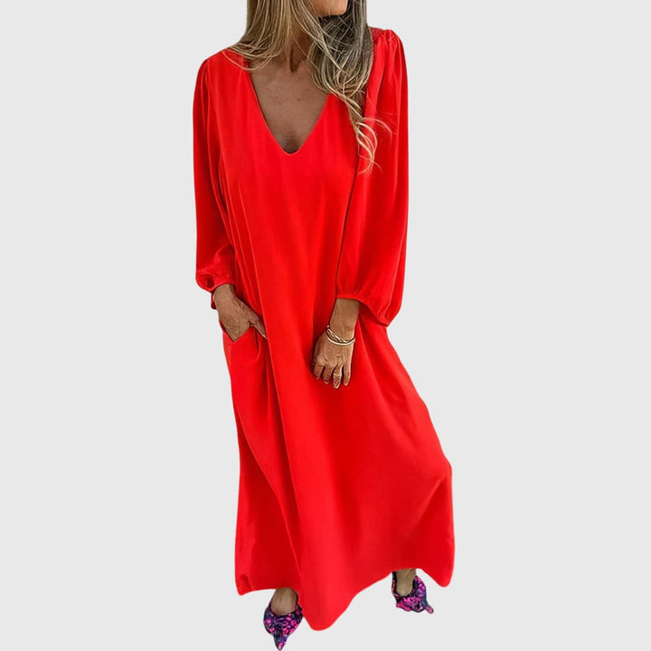 Emma & Rose Cape Town Carol™ long boho dress with pockets, flowing fabric, and bohemian style, displayed on a model.