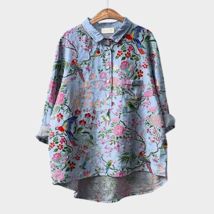 Elegant blouse by Emma & Rose Cape Town, featuring a floral bird blue design, with soft fabric and stylish fit.