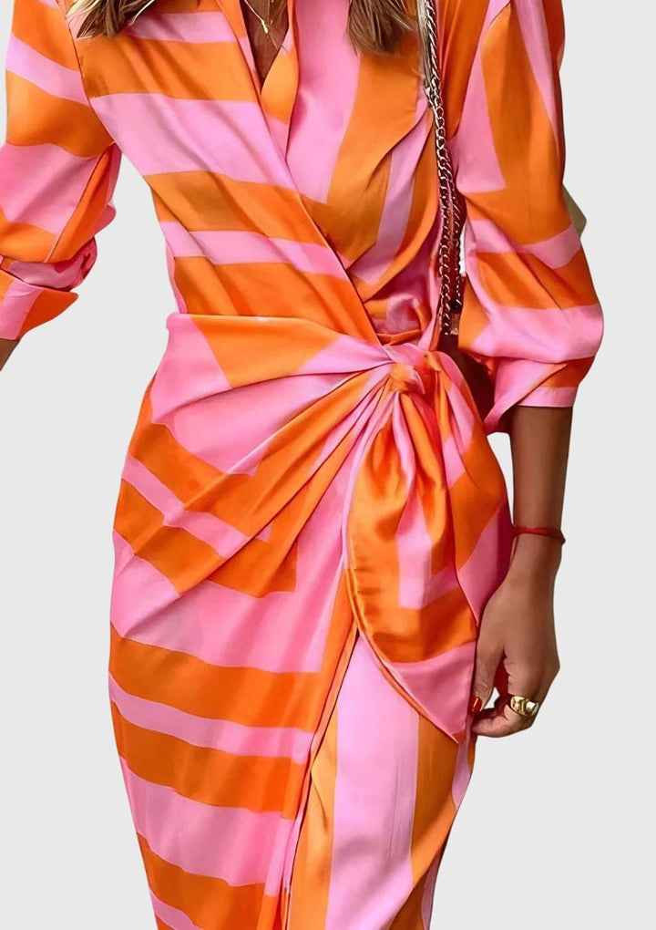 Everly™ Elegant Wrap Dress by Emma & Rose Cape Town featuring a stylish printed design and flowing fabric.