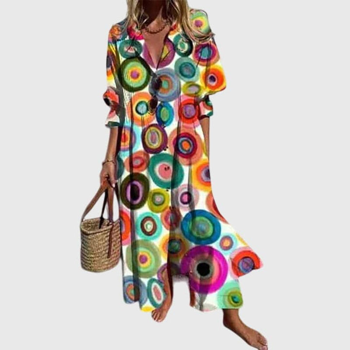 Zariah™ elegant bohemian dress by Emma & Rose Cape Town, featuring flowing fabric and intricate patterns, displayed on a mannequin.