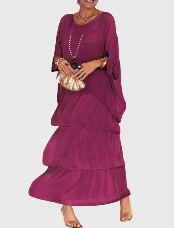 Long flowing elegant dress by Emma & Rose Cape Town, featuring a sleek silhouette and intricate detailing in a graceful design.