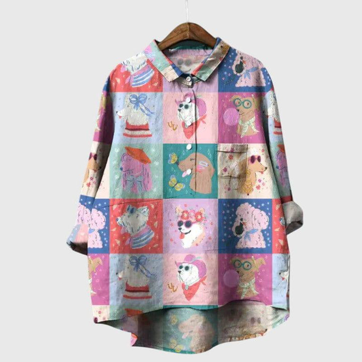 Elegant Emma & Rose Cape Town Elva™ blouse in soft fabric with a stylish neckline and long sleeves, displayed on a hanger.
