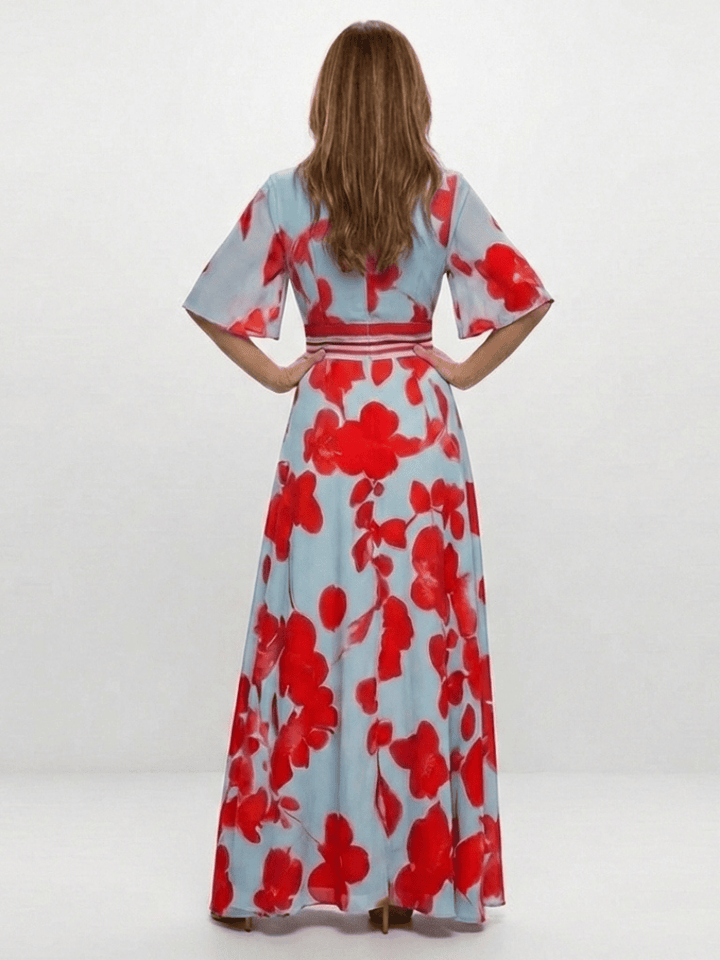 Corinne™ floral maxi dress by Emma & Rose Cape Town featuring long sleeves and a flowy, patterned fabric.