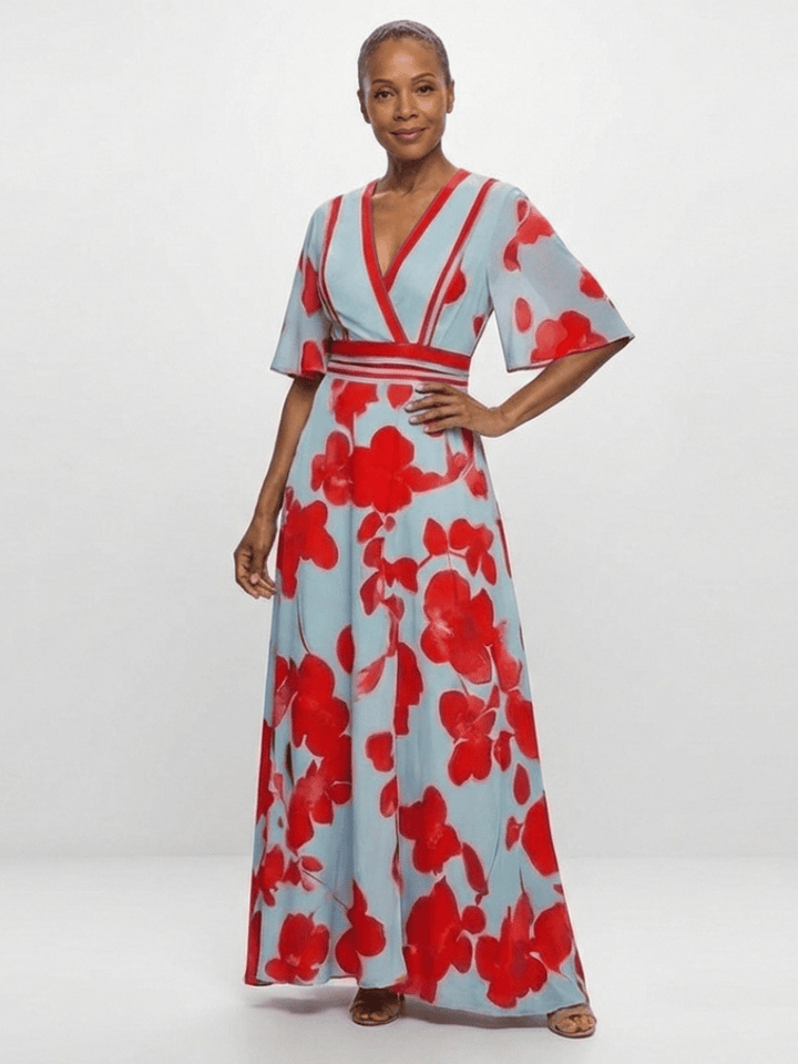Corinne™ floral maxi dress by Emma & Rose Cape Town, featuring long sleeves and vibrant floral pattern, displayed on a hanger.