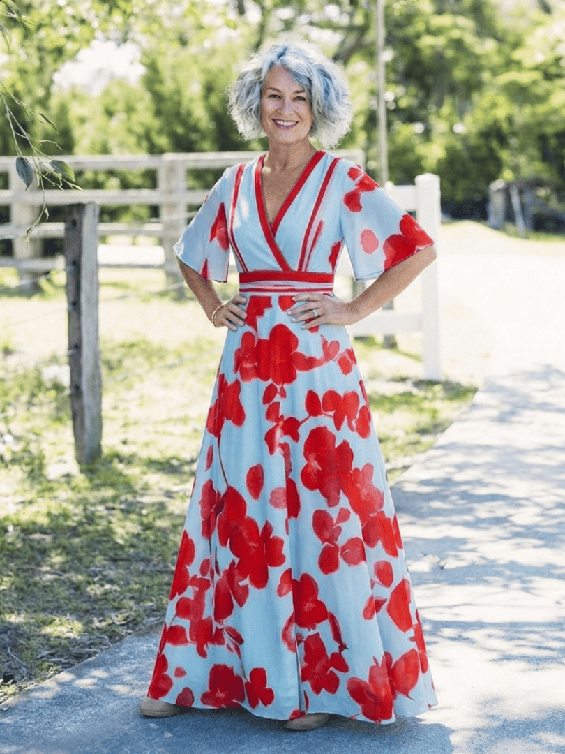 Corinne™ floral maxi dress with long sleeves by Emma & Rose Cape Town, featuring vibrant floral patterns and flowing fabric.