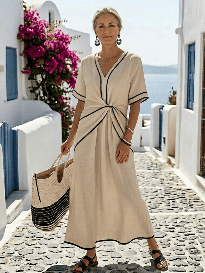 Emma & Rose Cape Town Linnea™ gathered waist midi dress with floral print and flowy fabric on a model.