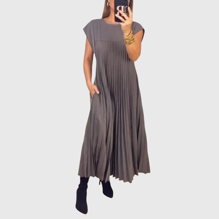 Beige Mariana™ elegant dress by Emma & Rose Cape Town, featuring a stylish design and tailored fit, displayed on a mannequin.