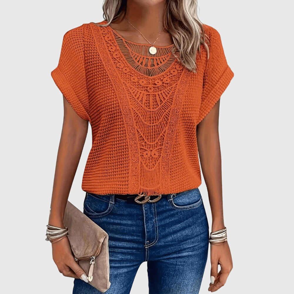 Beige Pearl™ Ibiza Blouse by Emma & Rose Cape Town, featuring elegant fabric and stylish design, displayed on a hanger.