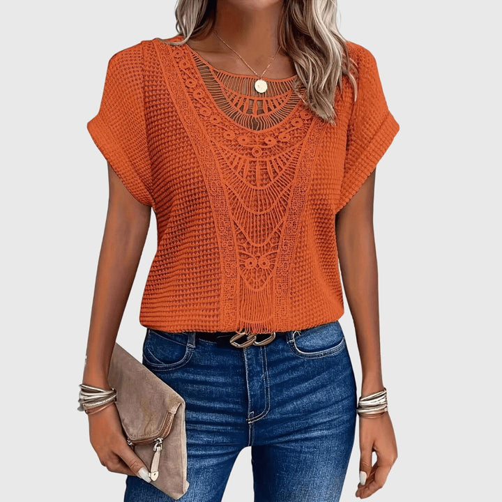 Beige Pearl™ Ibiza Blouse by Emma & Rose Cape Town, featuring elegant fabric and stylish design, displayed on a hanger.