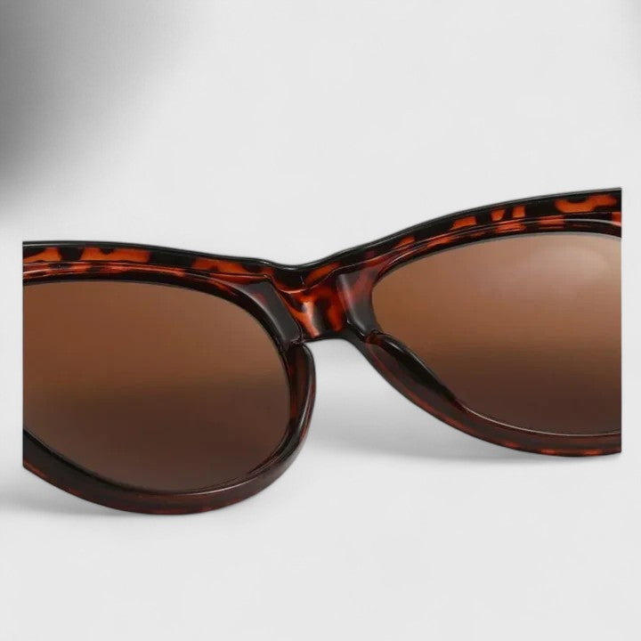 Emma & Rose Cape Town Journii stylish black sunglasses with sleek frame and tinted lenses, outdoor setting.