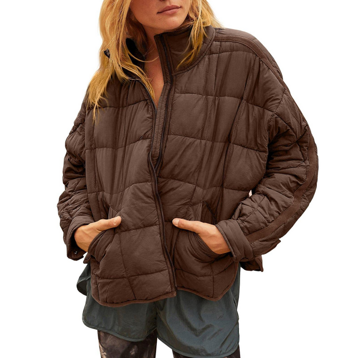 Black April™ compact zip puffer jacket by Emma & Rose Cape Town, shown on a hanger with a close-up of the quilted design.