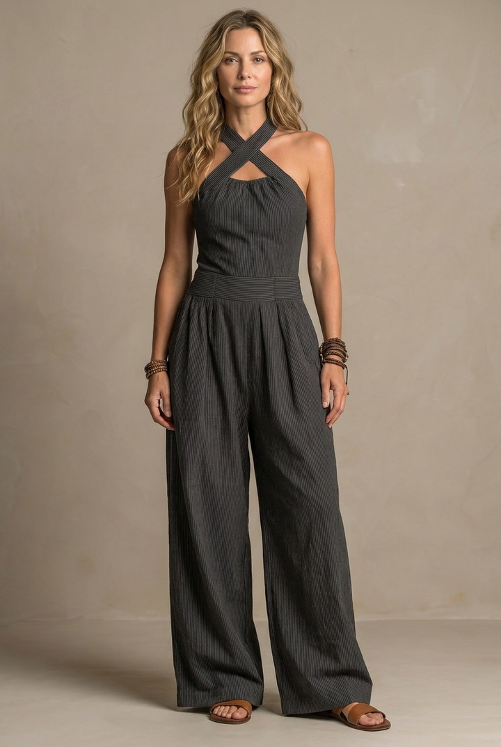 Black Ariana jumpsuit with crossed neckline by Emma & Rose Cape Town, featuring elegant, fitted design and stylish details.