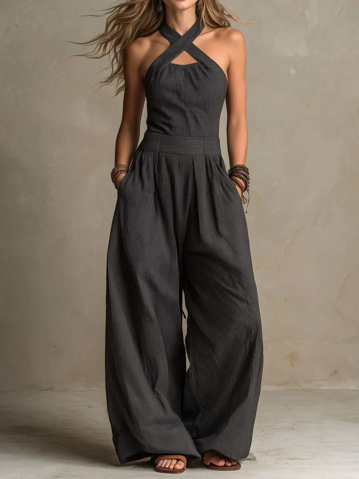 Black Ariana jumpsuit by Emma & Rose Cape Town featuring an elegant crossed neckline and tailored fit.