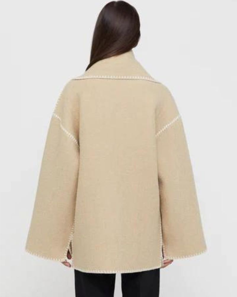 Black Jayzmarah™ stylish jacket by Emma & Rose Cape Town, shown on a hanger with detailed fabric texture.