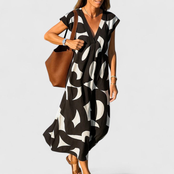Black Lysandra™ sophisticated maxi dress by Emma & Rose Cape Town, featuring elegant flowing fabric and a stylish silhouette.