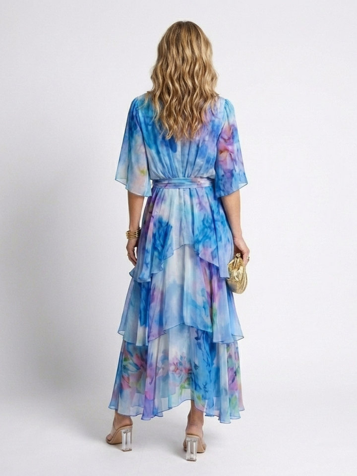 Emma & Rose Cape Town Calista Sheer Layered V Dress in blue, featuring a stylish, flowing layered design and V neckline.