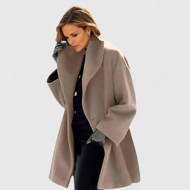 Emma & Rose Cape Town Oravienne™ elegant blue coat displayed on a hanger, showcasing its stylish design and fabric details.