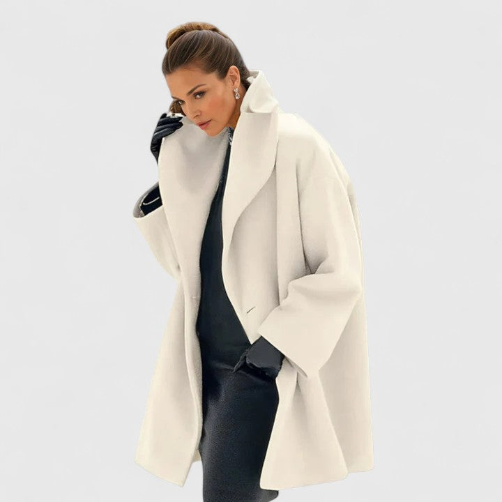 Blue Oravienne™ Elegant Coat by Emma & Rose Cape Town, displayed on a hanger with detailed fabric texture and classic design.