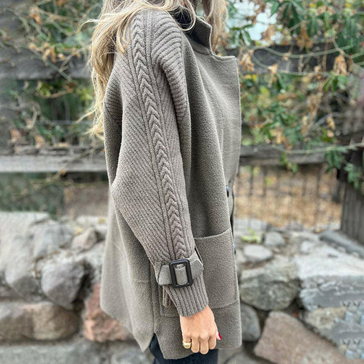Taupe Emma & Rose Cape Town Vaesa sophisticated coat displayed on a hanger, showcasing its elegant design and tailored fit.