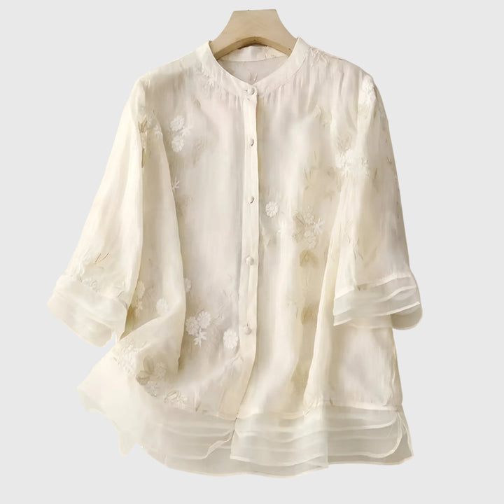 Cream Nellie™ elegant top by Emma & Rose Cape Town with embroidered floral details, stylish and sophisticated for any occasion.
