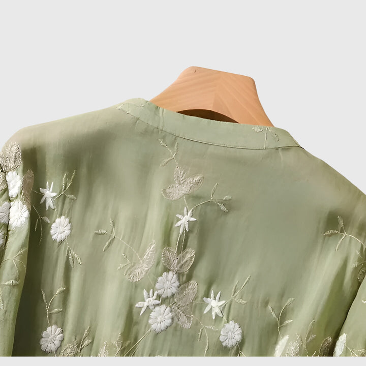 Cream Nellie™ elegant top with embroidered floral designs by Emma & Rose Cape Town, featuring delicate flower embroidery.