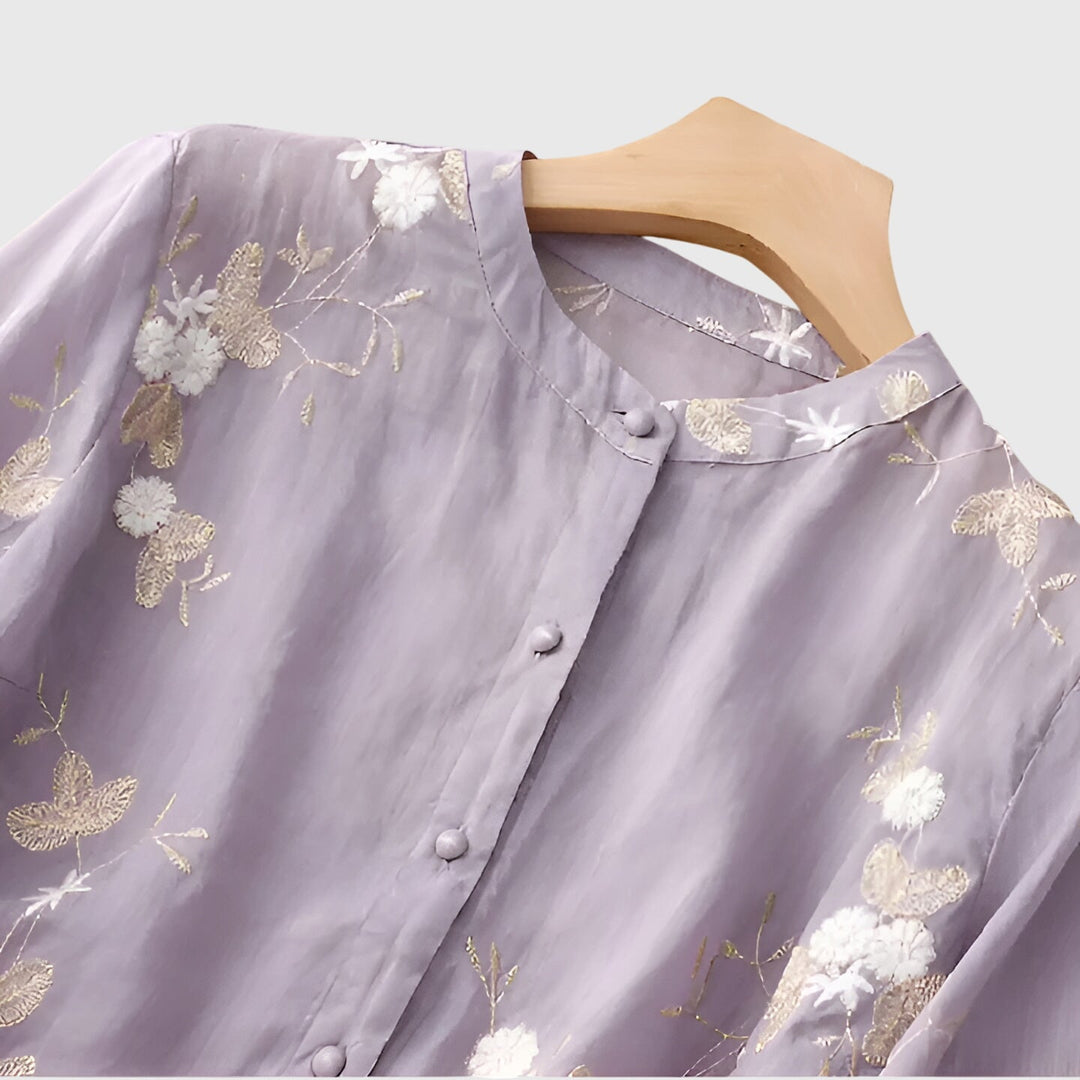 Cream Nellie™ elegant top by Emma & Rose Cape Town with embroidered floral details and classic design.