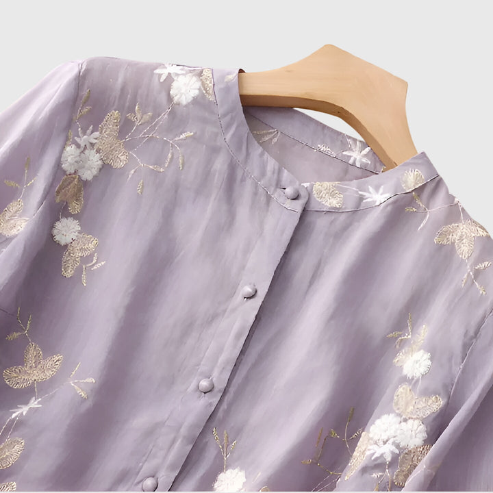 Cream Nellie™ elegant top by Emma & Rose Cape Town with embroidered floral details and classic design.