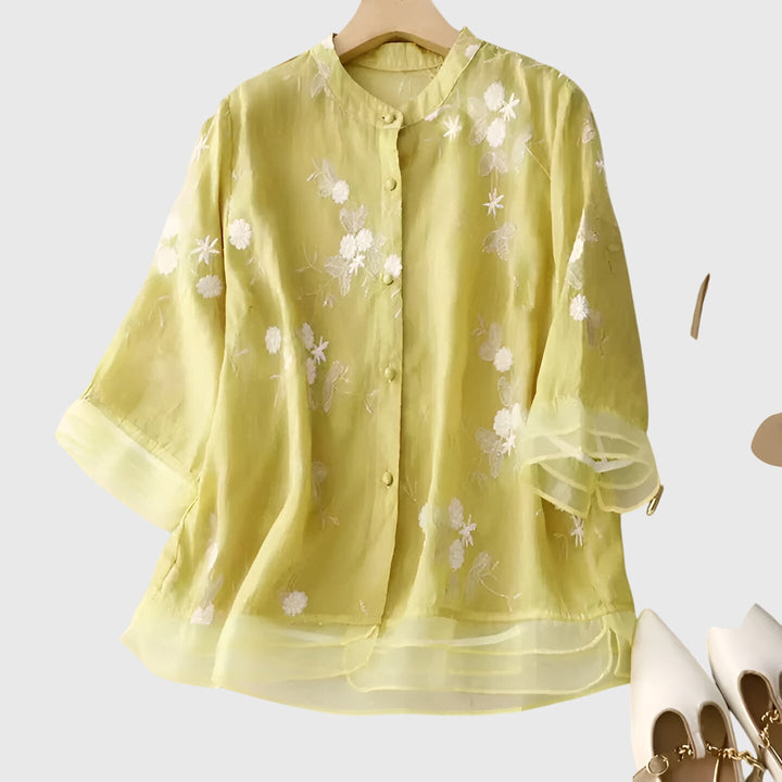 Cream Nellie™ elegant top with embroidered floral pattern from Emma & Rose Cape Town, showcasing detailed flower embroidery.