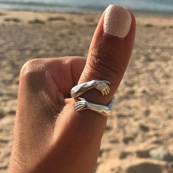 Silver Embrace Ring by Emma & Rose Cape Town featuring a sleek, minimalist design on a plain background.