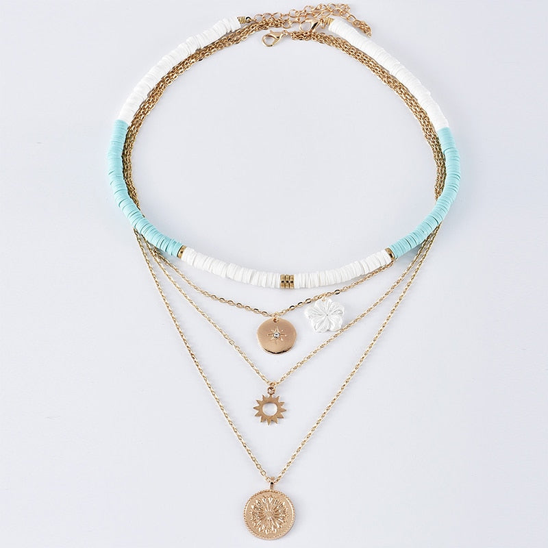 Simone™ necklace set by Emma & Rose Cape Town featuring layered gold-tone chains with pendant charms.